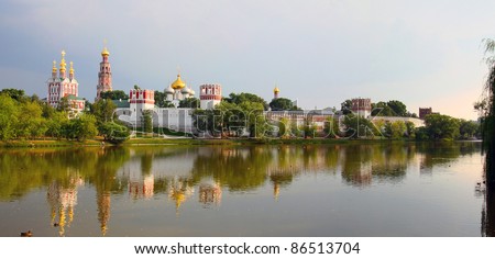 Novodevichy Convent with white walls on background of stormy sky, clouds