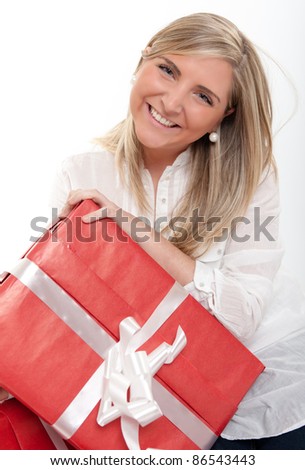 Laughing blonde young woman holding a present
