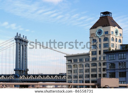 city view of New York (USA) with Manhattan Bridge and house facade in sunny ambiance