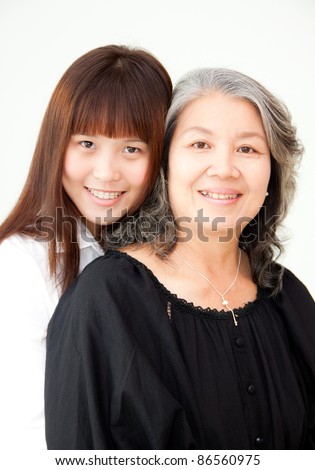 a young happy teenager hugs a happy elderly woman