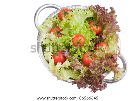 Washed fresh tomatoes with salad in colander