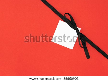 Real Brown Ribbon Bow with Blank Note card Tag on festive Orange Background