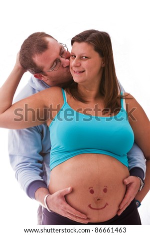 man embraces and kisses a  pregnant woman