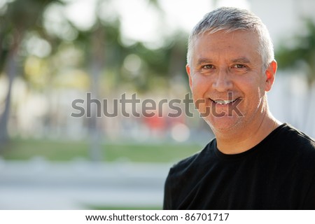 Handsome unshaven middle age man in an outdoor setting. Royalty-Free Stock Photo #86701717