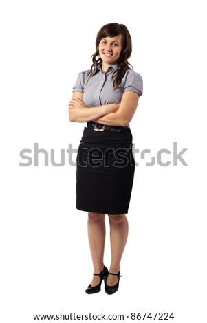 Portrait of a confident young business woman standing with folded hands, isolated over white background