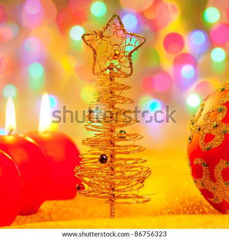 Christmas golden tree with baubles and candles in blur lights [Photo Illustration]