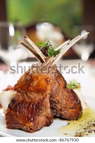 Raw rack of lamb fried with aromatic olive oil, herbs and spices Royalty-Free Stock Photo #86767930