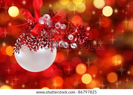 Red and white Christmas tree decorations on lights background