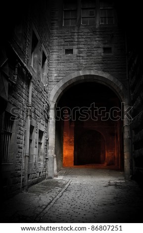 Dark empty courtyard in Edinburgh, Scotland with mysterious glowing archway