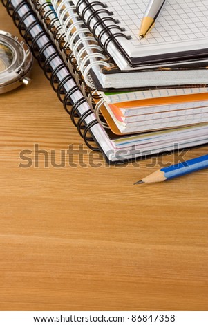 notebook and pens on wood background texture