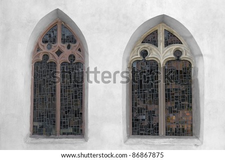 outdoor shot showing two old church windows