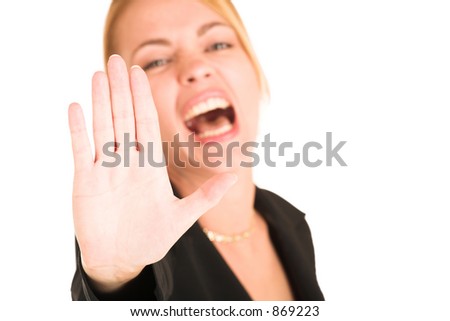 Blonde business lady in formal black suit.  Showing stop sign.  Shallow depth of field - hand in focus, face out of fucus.