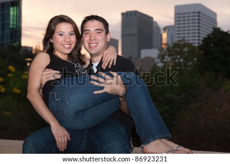 Attractive young multicultural couple outdoors in a park setting.