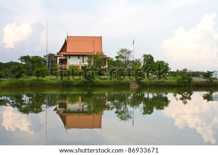 Thai-style clock tower with a traditional boat race pictures.