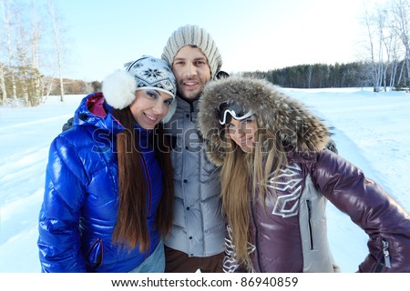 Group of young people having winter rest outdoor.