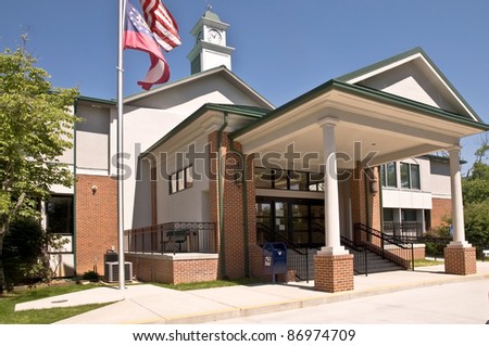 A small county courthouse office building with new entrance addition. Royalty-Free Stock Photo #86974709