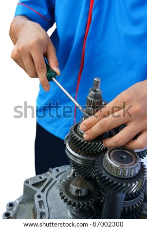 closed up of a mechanic fixing an automotive gear components