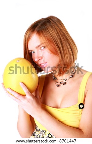 Girl holds in really big citrus fruit - pamelo