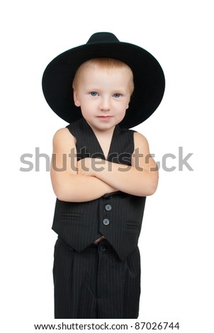 A serious little boy in a vest