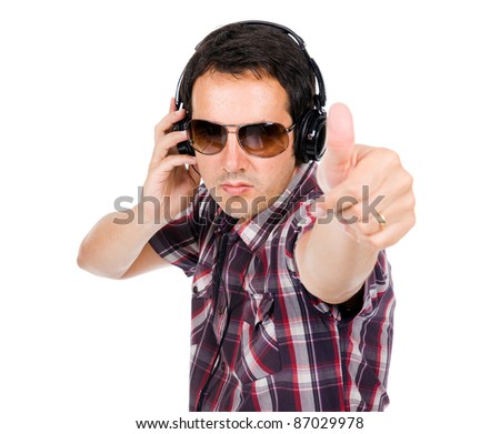 Happy young man with thumb up and listening music
