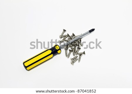 an isolated short of yellow handle screwdriver and screws