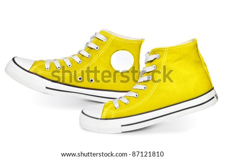 Pair of  new yellow sneakers isolated on white background