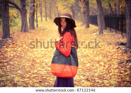 fashion girl standing in the autumn forest