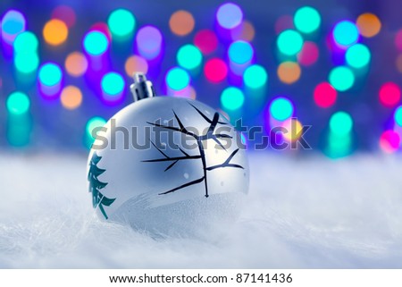Christmas bauble in silver with tree and colorful lights