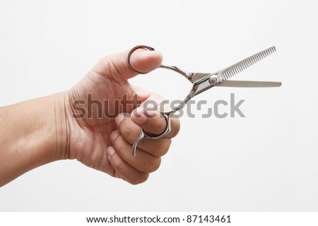 hand holding scissors on white background