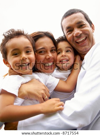 family lifestyle portrait of a mum and dad with their two kids having fun outdoors