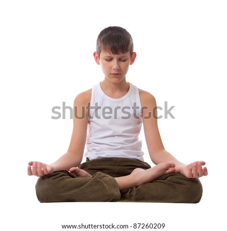 Boy sitting on floor meditating. Yoga. Lotus Position. Royalty-Free Stock Photo #87260209