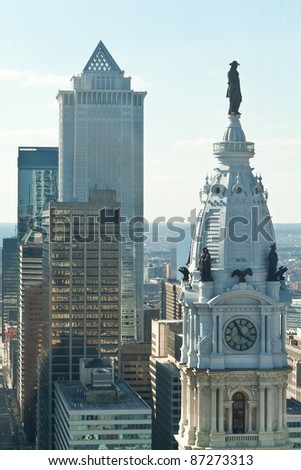 City Hall  with a statue of William Penn and tall buildings of downtown Philadelphia.  For many years there was an agreement to not allow any building to be taller then William Penn's hat.