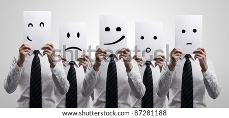 Five business men holding a card with emotional face. On a gray background