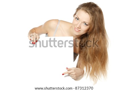 Beautiful young female pointing at blank copy-space over white background