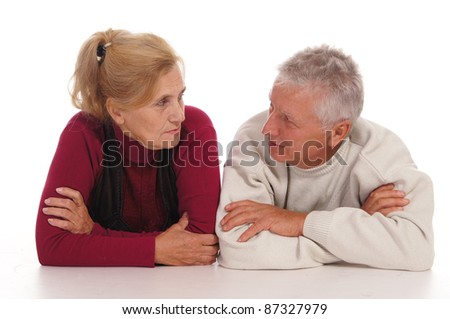 cute elderly couple posing on a white
