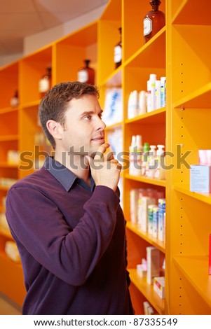 Pensive man buying some medicine in a pharmacy