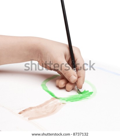 child painting a tree using black painting brush