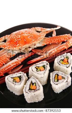 Maki Rolls and California rolls made of fresh raw Salmon, Tuna and Eel . on black dish with boiled crab . Maki Sushi and Nigiri