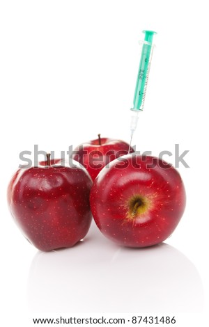 red apples with syringe injected isolated on white background