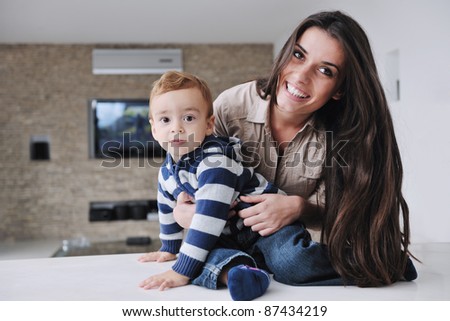 portrait of a happy mom and son together in modern living room home indoor