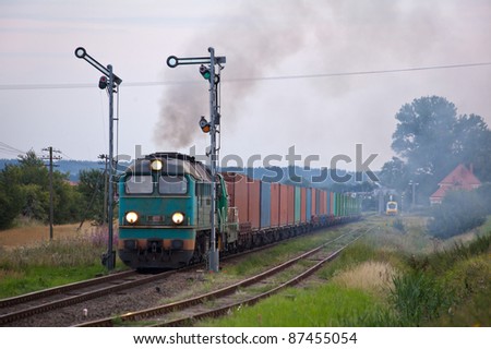 Freight train hauled by the diesel locomotives starting from the station