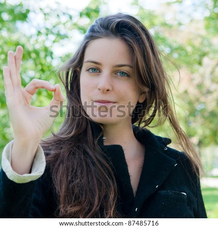 young woman portrait with OK on the nature