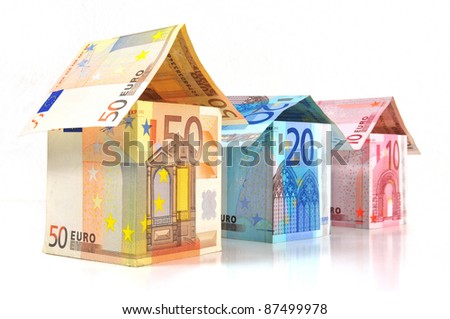 Three money houses with Euro banknotes on white background