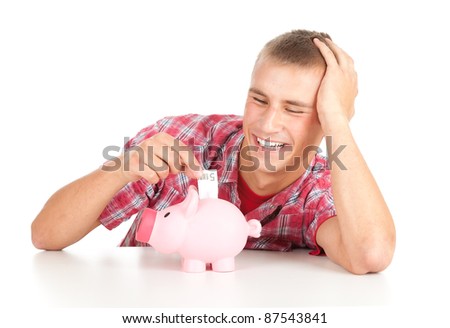 young man putting five euro in piggy bank