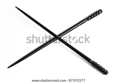 Two Black chopsticks isolated on white ornate decorations