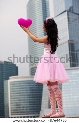 girl in a pink dress with heart in Big City