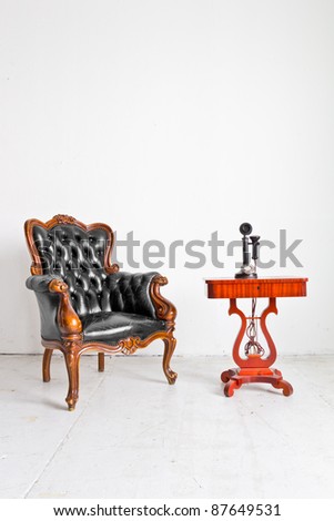 vintage luxury armchair and telephone in white room