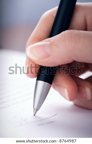 The woman signs the contract a ball pen
