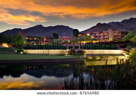 Long exposure of a luxury hotel resort.  A golf course and pond is in the foreground and foothill mountains in the background. Royalty-Free Stock Photo #87656980