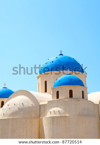 Church domes against the blue sky in Perissa, Santorini, Greece